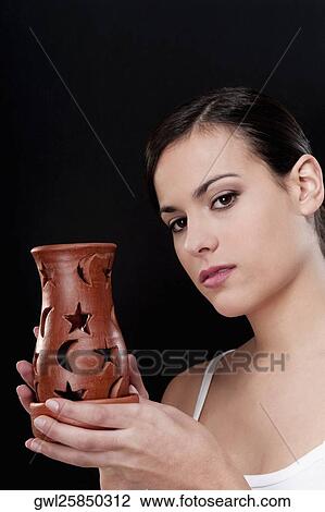Portrait of a woman holding an incense burner View Large Photo Image Stock Image - Portrait of a woman holding an incense burner. Fotosearch