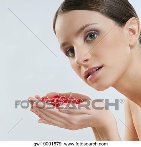 Portrait of a woman holding bath beads View Large Photo Image Stock Photo - Portrait of a woman holding bath beads. Fotosearch