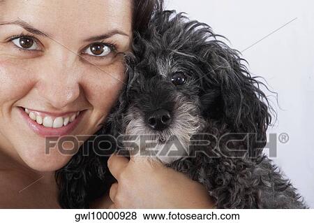 Portrait of a woman hugging a Poodle and smiling View Large Photo Image Stock Photo - Portrait of a woman hugging a Poodle and smiling. Fotosearch