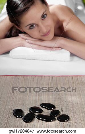 Portrait of a woman lying on a massage table View Large Photo Image Stock Photo - Portrait of a woman lying on a massage table. Fotosearch