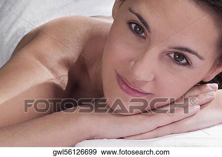 Portrait of a woman lying on a massage table View Large Photo Image Stock Photo - Portrait of a woman lying on a massage table. Fotosearch