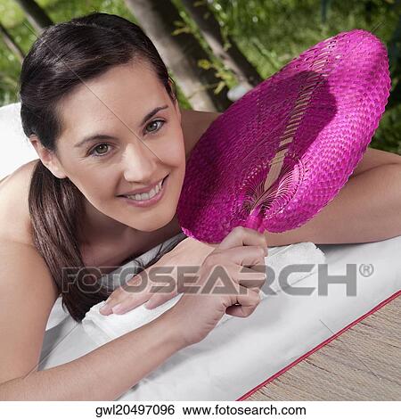 Portrait of a woman lying on a massage table and smiling View Large Photo Image Stock Photograph - Portrait of a woman lying on a massage table and smiling. Fotosearch