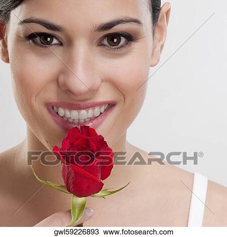 Portrait of a woman smelling a rose View Large Photo Image Stock Image - Portrait of a woman smelling a rose . Fotosearch