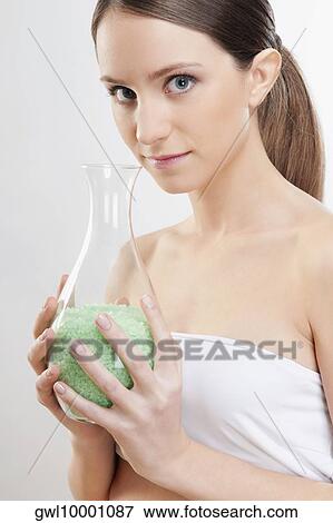 Stock Photo - Portrait of a woman smelling bath crystals. Fotosearch