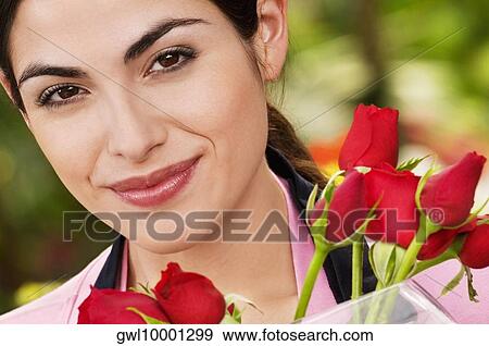 Portrait of a woman smiling in a greenhouse View Large Photo Image Stock Photo - Portrait of a woman smiling in a greenhouse. Fotosearch