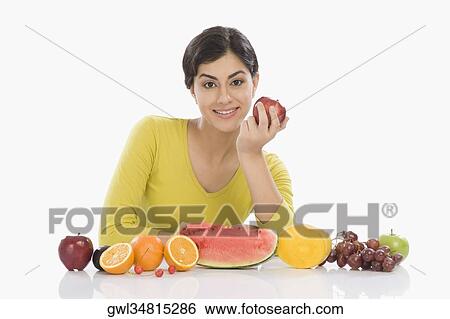 Portrait of a woman with a row of assorted fresh fruits View Large Photo Image Stock Photograph - Portrait of a woman with a row of assorted fresh fruits. Fotosearch