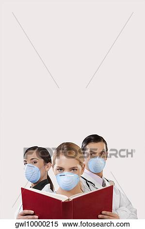 Portrait of doctors wearing flu masks View Large Photo Image Stock Photography - Portrait of doctors wearing flu masks. Fotosearch