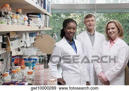 Portrait of three doctors smiling in a laboratory View Large Photo Image Stock Photo - Portrait of three doctors smiling in a laboratory. Fotosearch