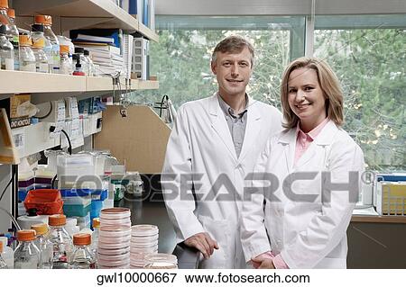Portrait of two doctors smiling in a laboratory View Large Photo Image Stock Photo - Portrait of two doctors smiling in a laboratory. Fotosearch