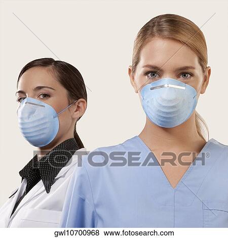 Portrait of two female doctors wearing flu masks View Large Photo Image Stock Photo - Portrait of two female doctors wearing flu masks. Fotosearch