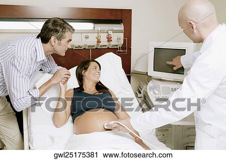 Pregnant woman going through an ultrasound scan View Large Photo Image Stock Image - Pregnant woman going through an ultrasound scan. Fotosearch