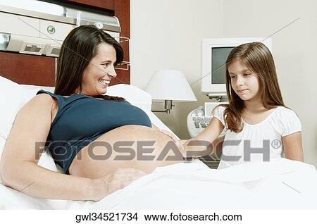 Pregnant woman in a hospital with her daughter View Large Photo Image Picture - Pregnant woman in a hospital with her daughter. Fotosearch