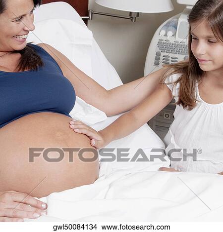 Pregnant woman in a hospital with her daughter View Large Photo Image Picture - Pregnant woman in a hospital with her daughter. Fotosearch