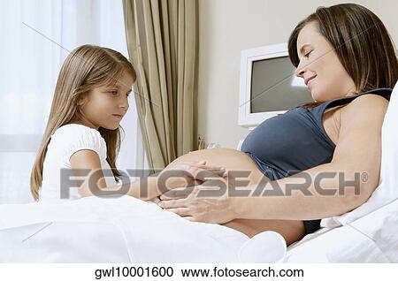 Pregnant woman in a hospital with her daughter View Large Photo Image Stock Image - Pregnant woman in a hospital with her daughter. Fotosearch