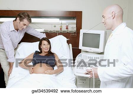 Pregnant woman in a hospital with her husband View Large Photo Image Stock Image - Pregnant woman in a hospital with her husband. Fotosearch