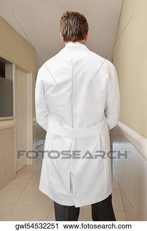 Rear view of a doctor standing at the corridor View Large Photo Image Stock Image - Rear view of a doctor standing at the corridor. Fotosearch