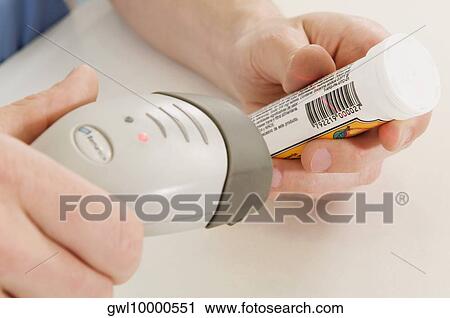 Sales clerk scanning the bottle price with a bar code reader View Large Photo Image Stock Image - Sales clerk scanning the bottle price with a bar code reader. Fotosearch
