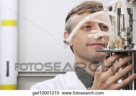 Stock Photography - Scientist working on a bioreactor headplate with mixer assembly and methanol sensor probe. Fotosearch