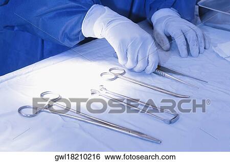 Surgeon choosing surgical scissors View Large Photo Image Stock Photograph - Surgeon choosing surgical scissors. Fotosearch