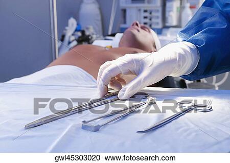 Surgeon holding surgical scissors in an operating room View Large Photo Image Stock Image - Surgeon holding surgical scissors in an operating room. Fotosearch
