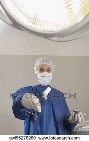 Surgeon holding surgical scissors in an operating room View Large Photo Image Stock Image - Surgeon holding surgical scissors in an operating room. Fotosearch