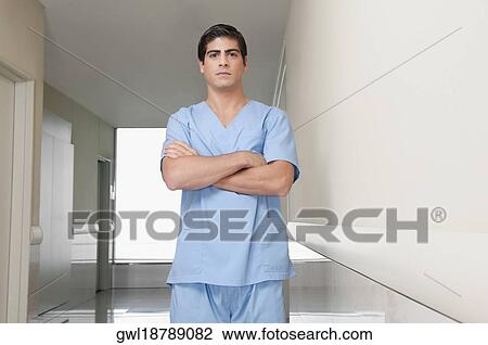 Surgeon standing in the corridor of a hospital View Large Photo Image Stock Image - Surgeon standing in the corridor of a hospital. Fotosearch