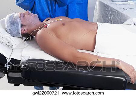 Surgeon with a patient in an operating room View Large Photo Image Stock Image - Surgeon with a patient in an operating room. Fotosearch