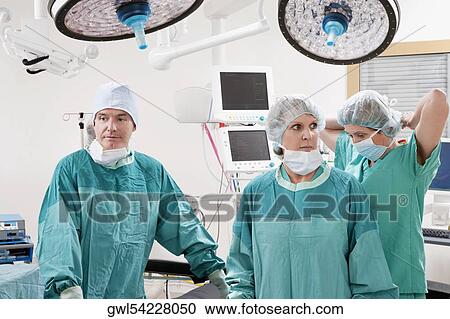 Surgeons performing a surgery in an operating room View Large Photo Image Stock Image - Surgeons performing a surgery in an operating room. Fotosearch