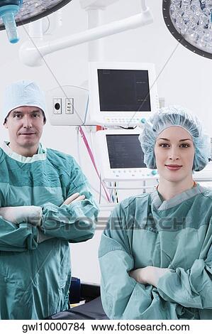 Surgeons smiling in an operating room View Large Photo Image Picture - Surgeons smiling in an operating room. Fotosearch