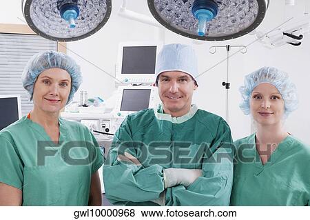 Stock Photo - Surgeons smiling in an operating room. Fotosearch