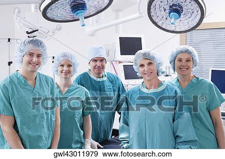 Surgeons smiling in an operating room View Large Photo Image Stock Photo - Surgeons smiling in an operating room. Fotosearch