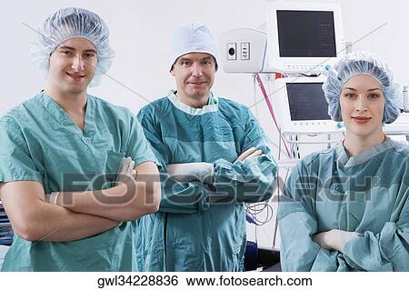 Stock Photograph - Surgeons smiling in an operating room. Fotosearch