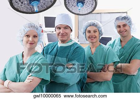 Stock Photography - Surgeons smiling in an operating room. Fotosearch