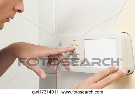 Technician operating an MRI scanner View Large Photo Image Stock Image - Technician operating an MRI scanner. Fotosearch