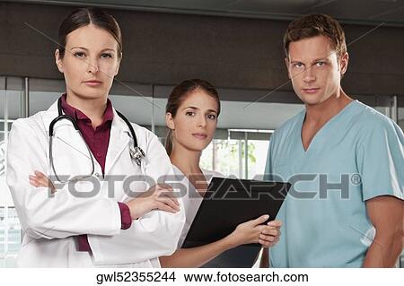 Three doctors standing together View Large Photo Image Picture - Three doctors standing together. Fotosearch