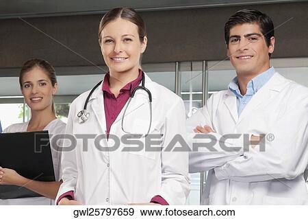 Three doctors standing together View Large Photo Image Stock Photo - Three doctors standing together. Fotosearch