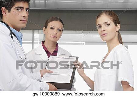 Three doctors with a medical report View Large Photo Image Stock Photo - Three doctors with a medical report. Fotosearch