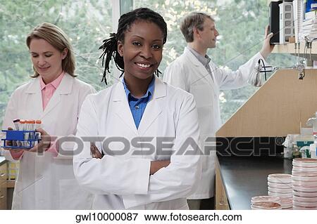 Three doctors working in a laboratory View Large Photo Image Stock Photo - Three doctors working in a laboratory. Fotosearch
