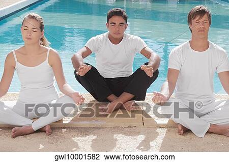 Three friends practicing yoga at the poolside View Large Photo Image Stock Image - Three friends practicing yoga at the poolside. Fotosearch