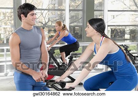 Three people working out in a gym View Large Photo Image Stock Image - Three people working out in a gym. Fotosearch
