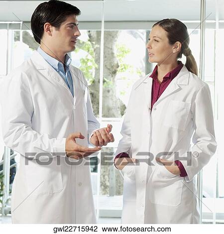 Two doctors discussing View Large Photo Image Stock Image - Two doctors discussing. Fotosearch