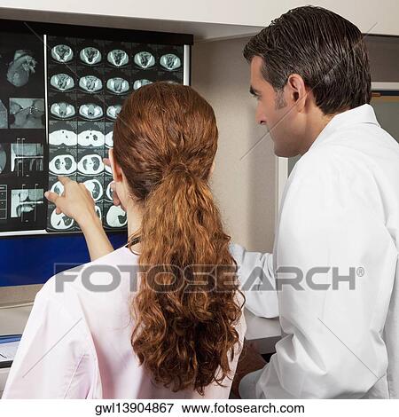 Two doctors examining MRI report View Large Photo Image Stock Photo - Two doctors examining MRI report. Fotosearch