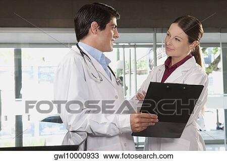 Two doctors with a clipboard View Large Photo Image Stock Image - Two doctors with a clipboard. Fotosearch
