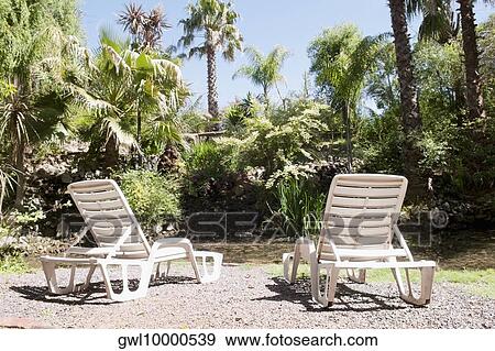 Stock Photo - Two lounge chairs in a tourist resort. Fotosearch
