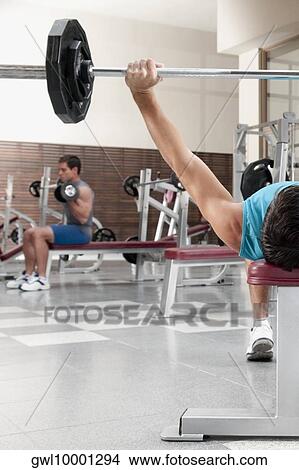 Two men exercising in a gym View Large Photo Image Picture - Two men exercising in a gym. Fotosearch