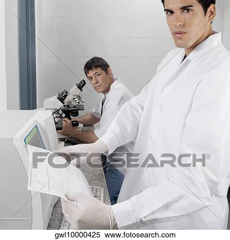 Two researchers working in a laboratory View Large Photo Image Stock Photography - Two researchers working in a laboratory. Fotosearch