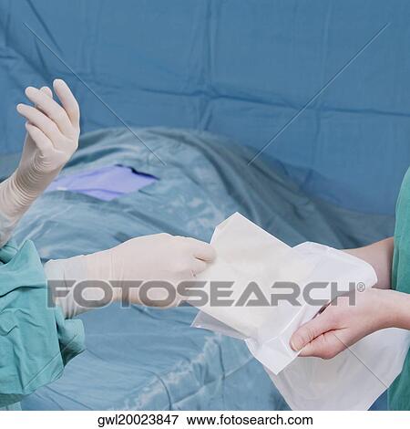 Two surgeons performing a surgery in an operating room View Large Photo Image Stock Photo - Two surgeons performing a surgery in an operating room. Fotosearch