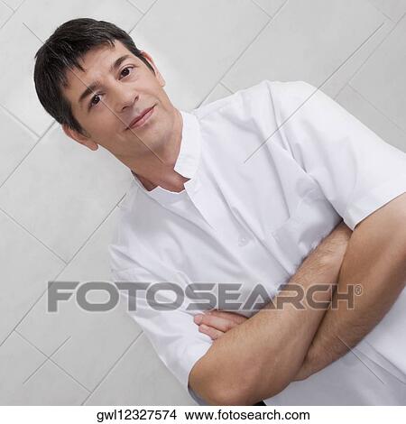 Vet standing with his arms crossed View Large Photo Image Picture - Vet standing with his arms crossed. Fotosearch