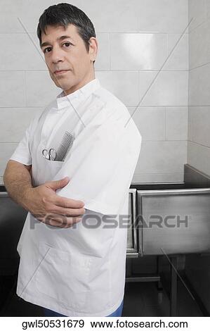Stock Photo - Vet standing with his arms crossed. Fotosearch
