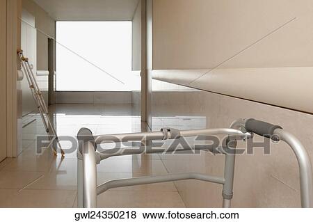 Walker and a crutch in the corridor of a hospital View Large Photo Image Stock Photo - Walker and a crutch in the corridor of a hospital. Fotosearch